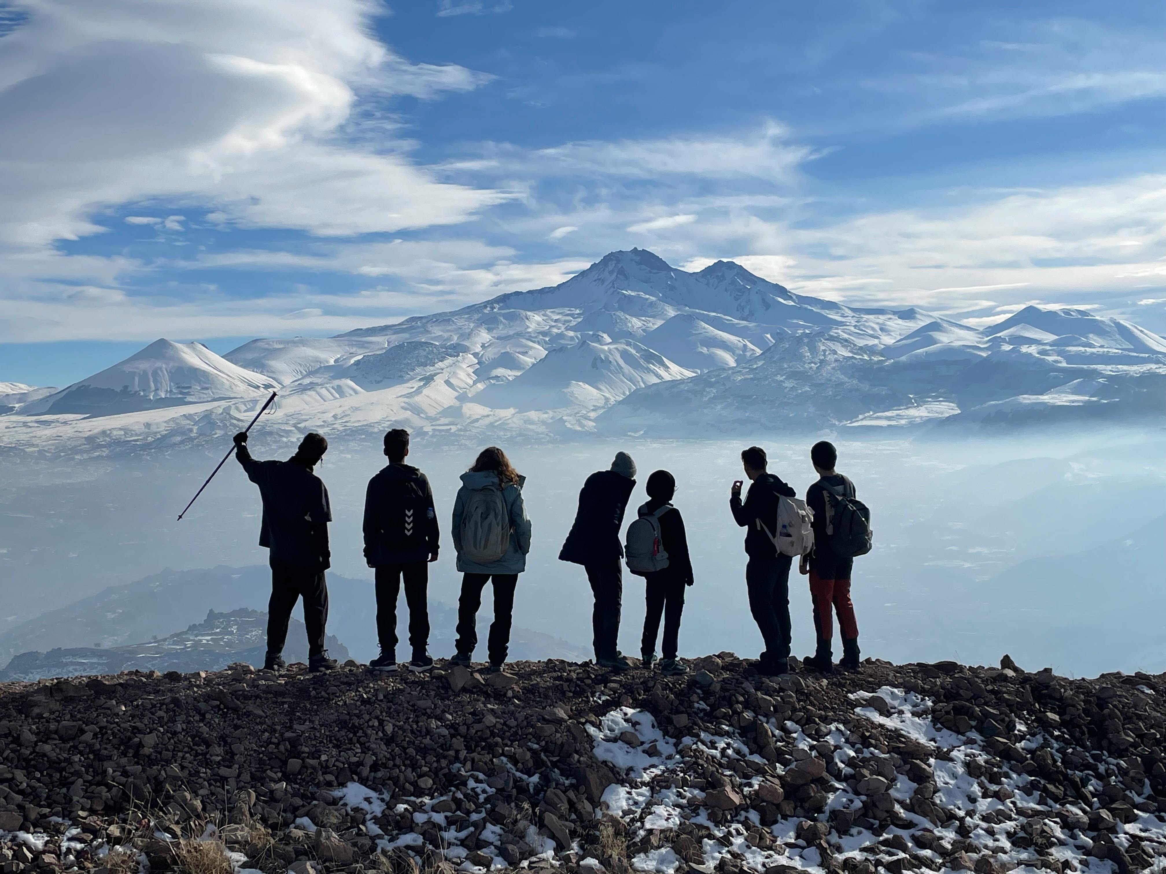 Aligned hikers on a mountain trail
